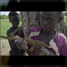 Nuba boys with clay made guns. An new generation is growing up playing with Kalashnikovs as the only children toys they know